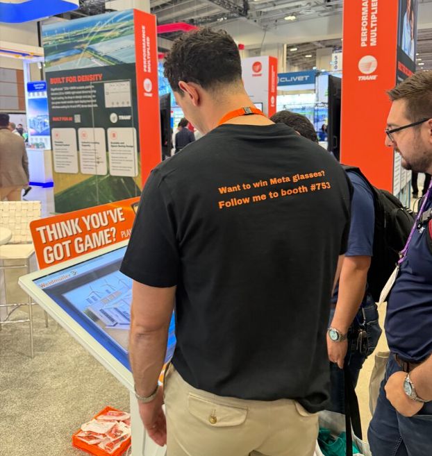 Booth visitor playing the kiosk game, wearing a Want to win Meta glasses shirt